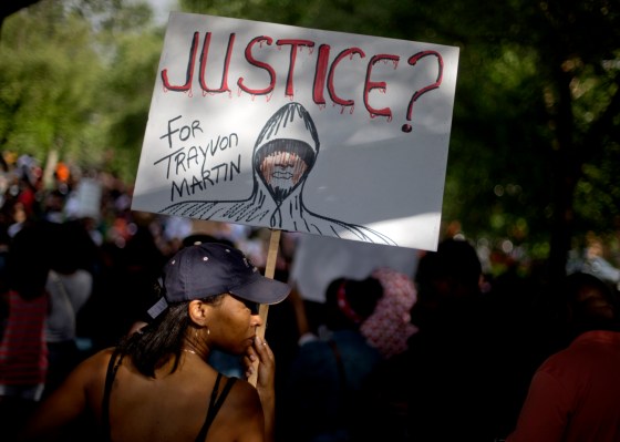 Sonia Medina, of Suwanee, Ga., holds a sign while joining a protest the day after George Zimmerman was found not guilty in the 2012 shooting death of teenager Trayvon Martin, Sunday, July 14, 2013, in Atlanta.